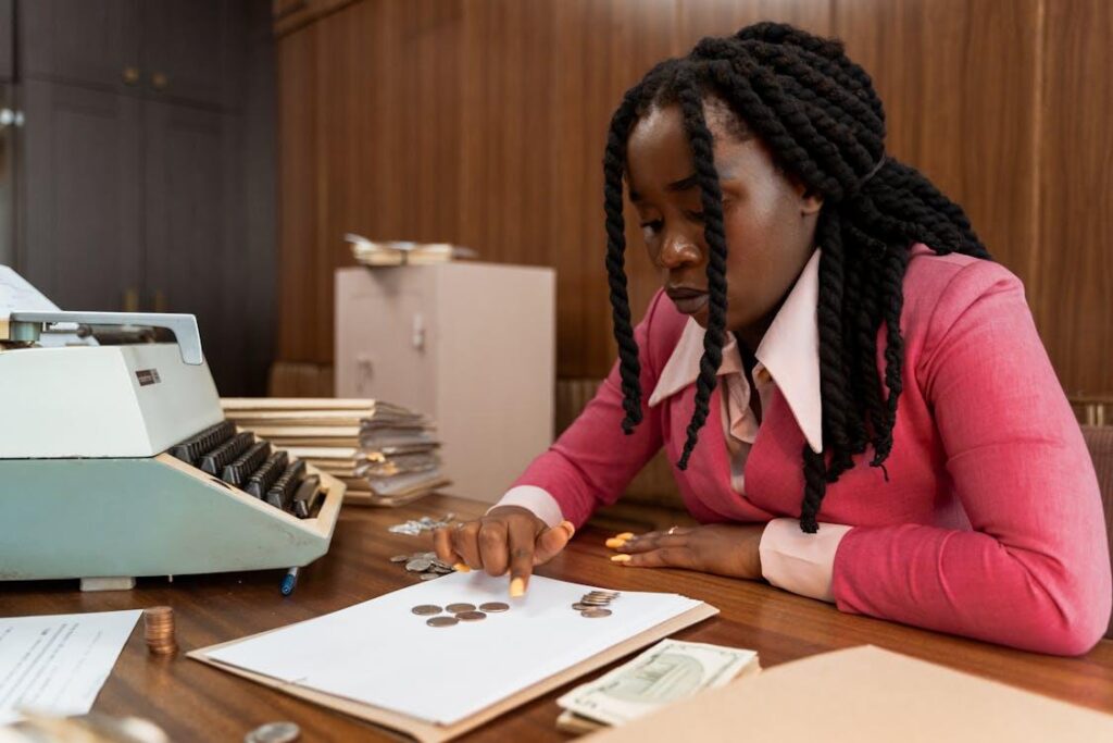 Woman counting coins at a desk